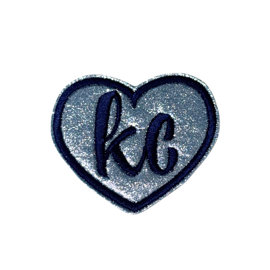 Silver glitter heart patch with navy “kc” embroidery and dark blue border, inspired by Sporting Kansas City team colors

