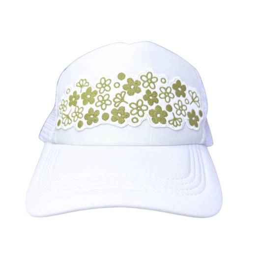 Front view of white trucker hat with vintage Pyrex Spring Blossom floral patch in olive green
