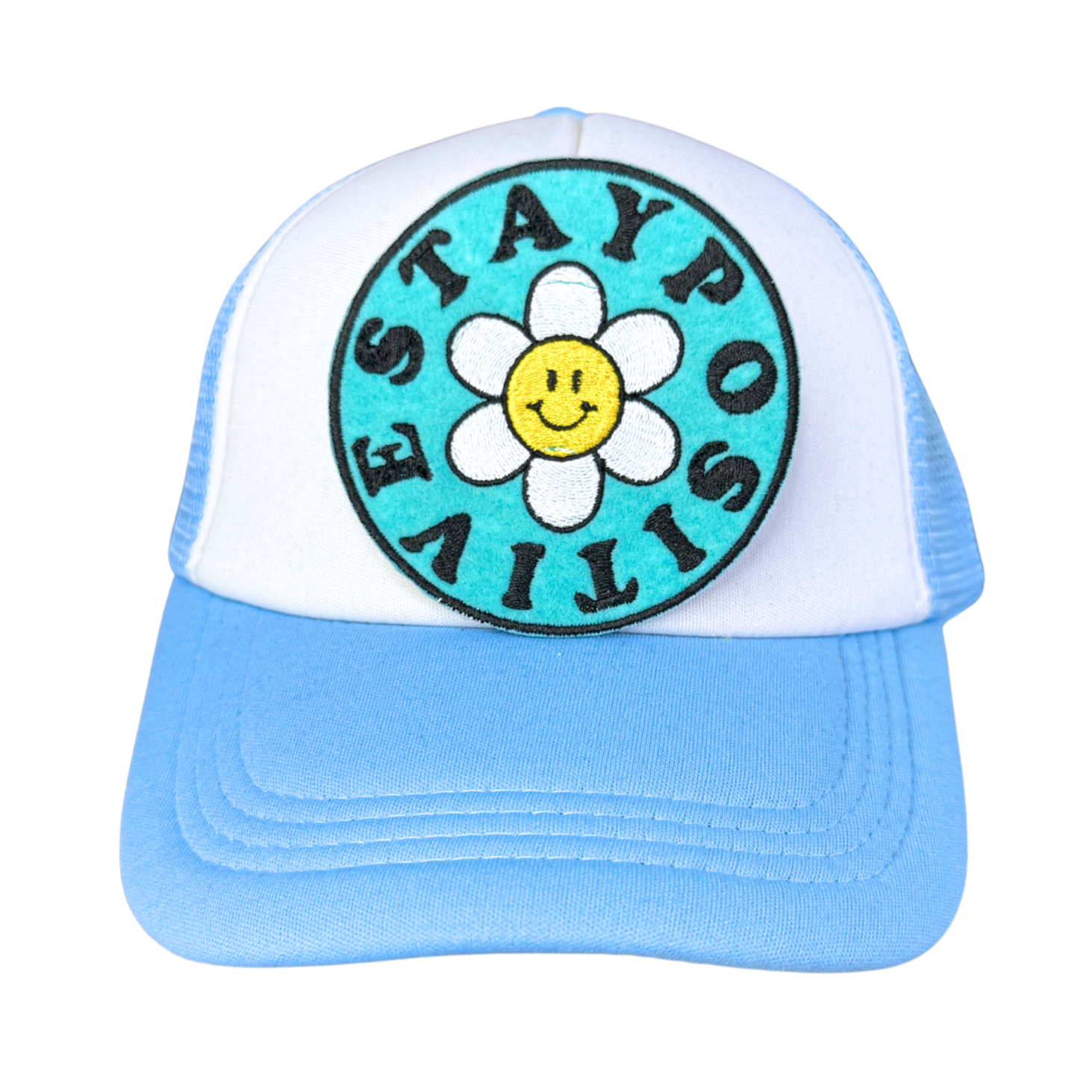 "Blue and white trucker hat featuring a colorful embroidered 'Stay Positive' patch with a smiley daisy."
