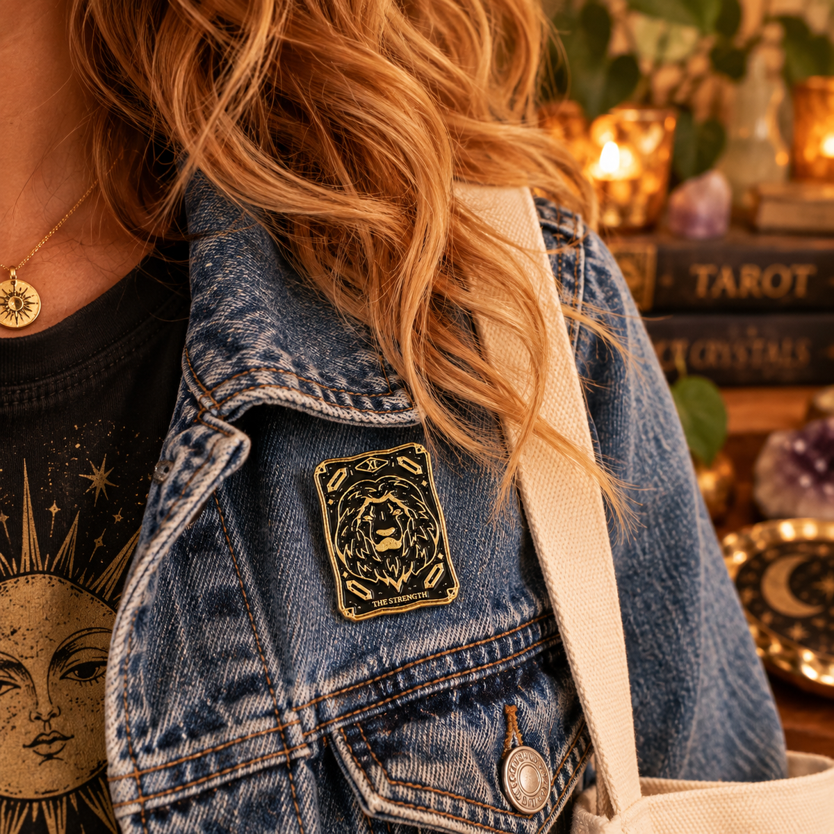 The Strength tarot lion enamel pin on denim jacket lifestyle image