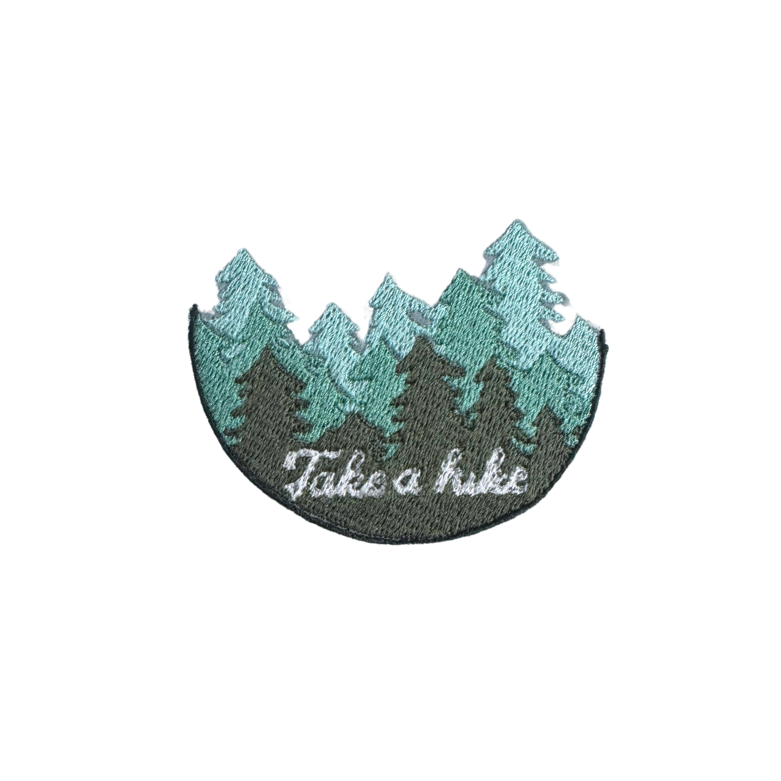 Handmade "Take a Hike" embroidered patch with pine trees and white text on a green and black background.
