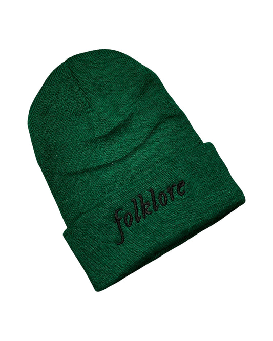 dark green knit beanie embroidered in black with the word "folklore"