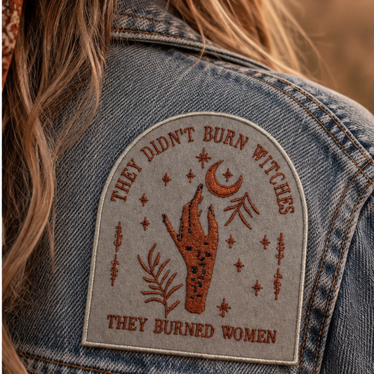 They Didn't Burn Witches embroidered patch worn on a denim jacket