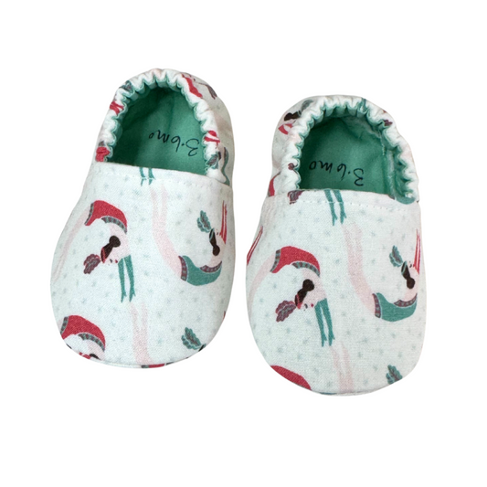 “Handmade soft sole baby shoes with trapeze artist women print, front view, 3-6 months”

