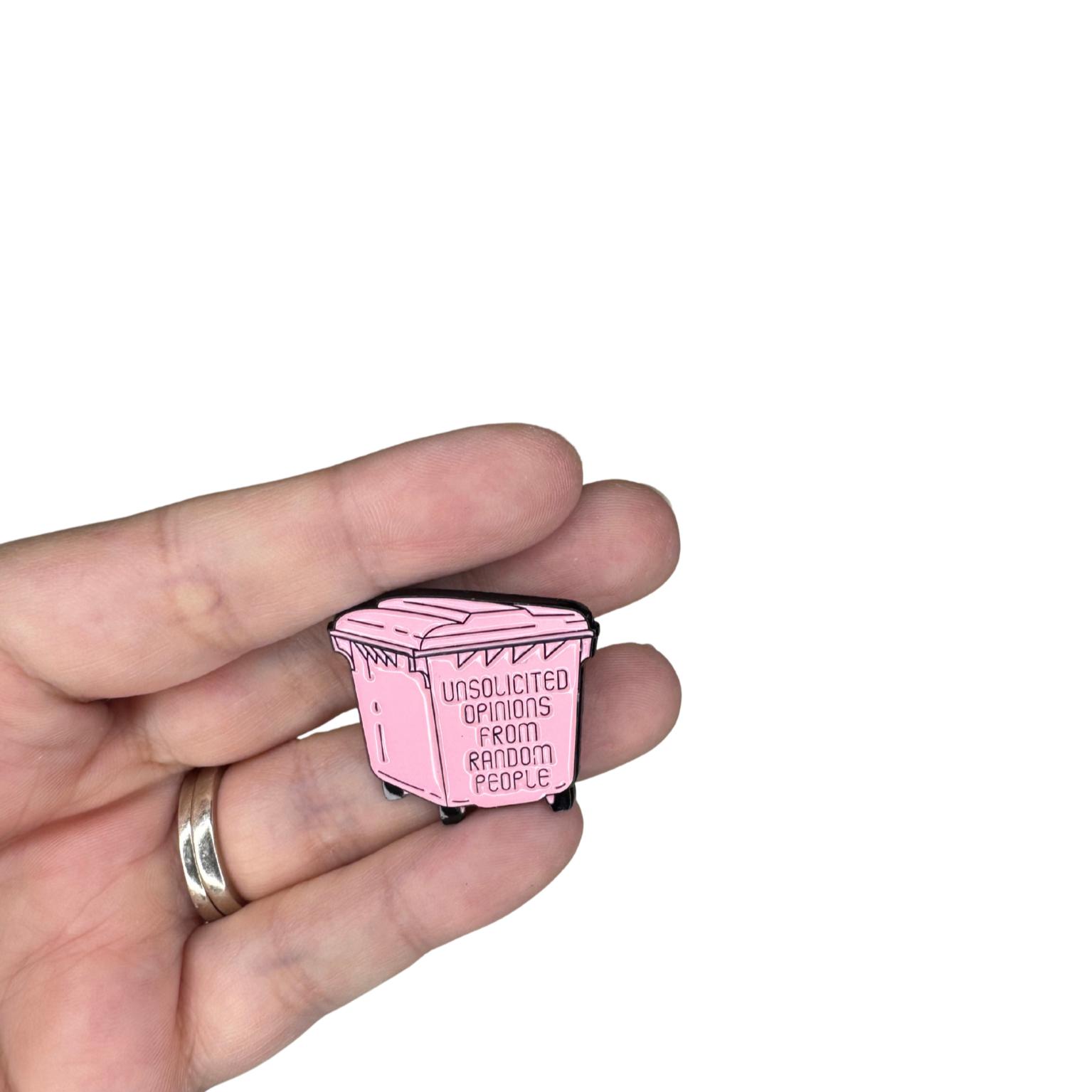 Pink dumpster pin held in hand for scale


