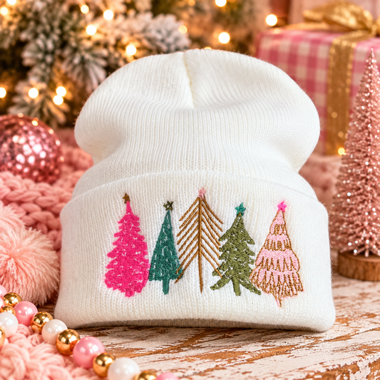 White embroidered Christmas tree beanie styled in a colorful holiday setting