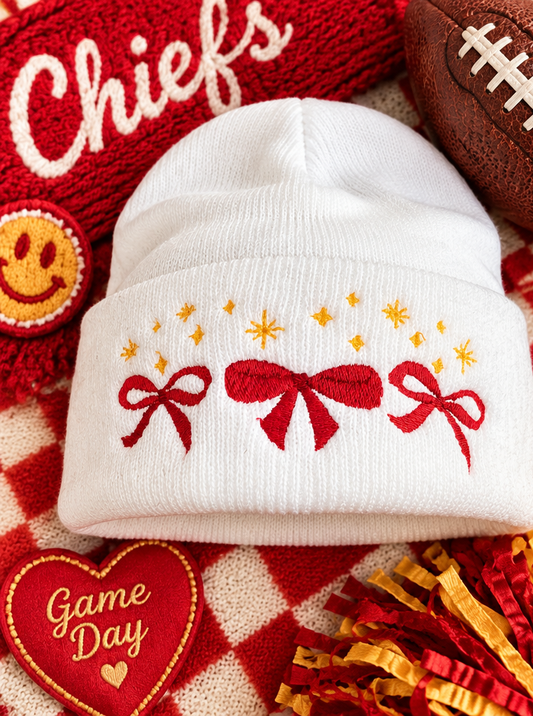 White embroidered beanie with red bows and gold stars, styled for Kansas City game day